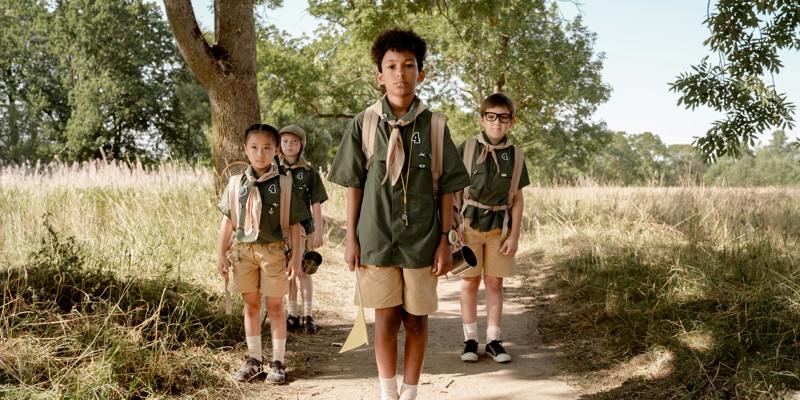 Four young scouts on a hiking trail
